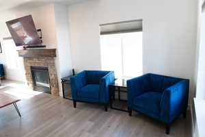 Sitting room with a fireplace and wood laminate floors