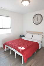 Bedroom 2 with wood laminate floors and baseboards