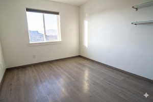 Unfurnished room with light wood-type flooring and baseboards