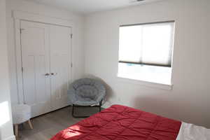 Bedroom 2 featuring a closet and wood laminate floors