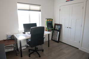 Bedroom 3 used as an office area with wood laminate finished floors