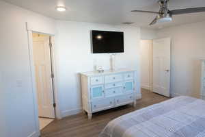Primary Bedroom featuring dark wood laminate flooring and a ceiling fan