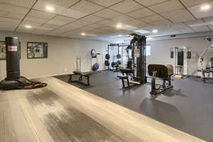 5th floor- Exercise room with a drop ceiling and recessed lighting