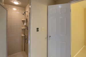 Full bathroom with a shower stall and light tile patterned floors