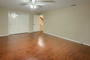 Unfurnished bedroom with dark wood finished floors, a closet, and ceiling fan