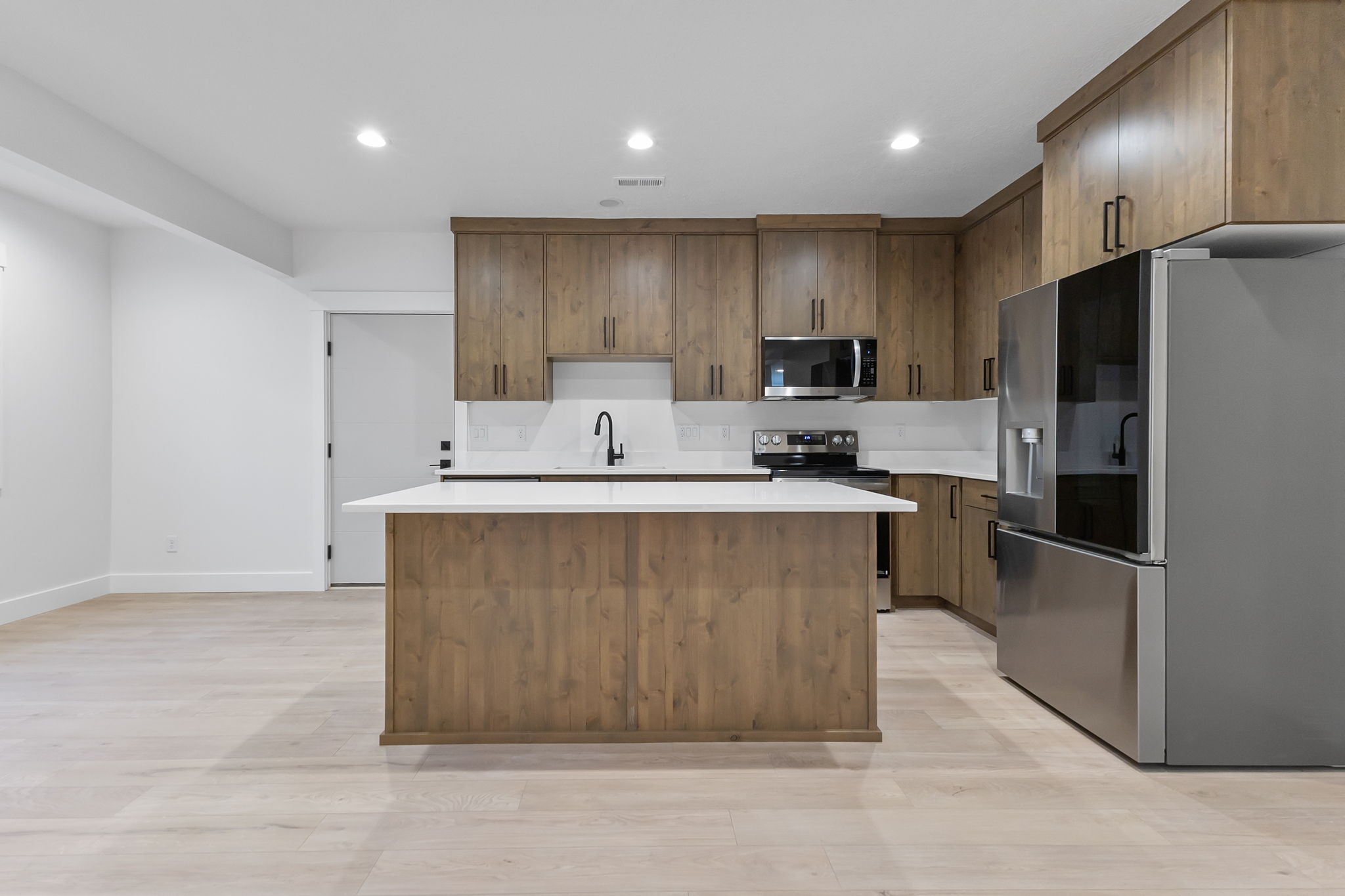 Kitchen featuring wood-finish cabinetry and a central island