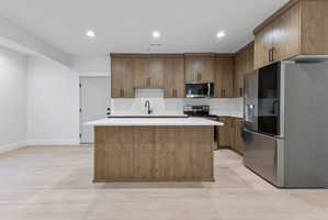Kitchen featuring wood-finish cabinetry and a central island