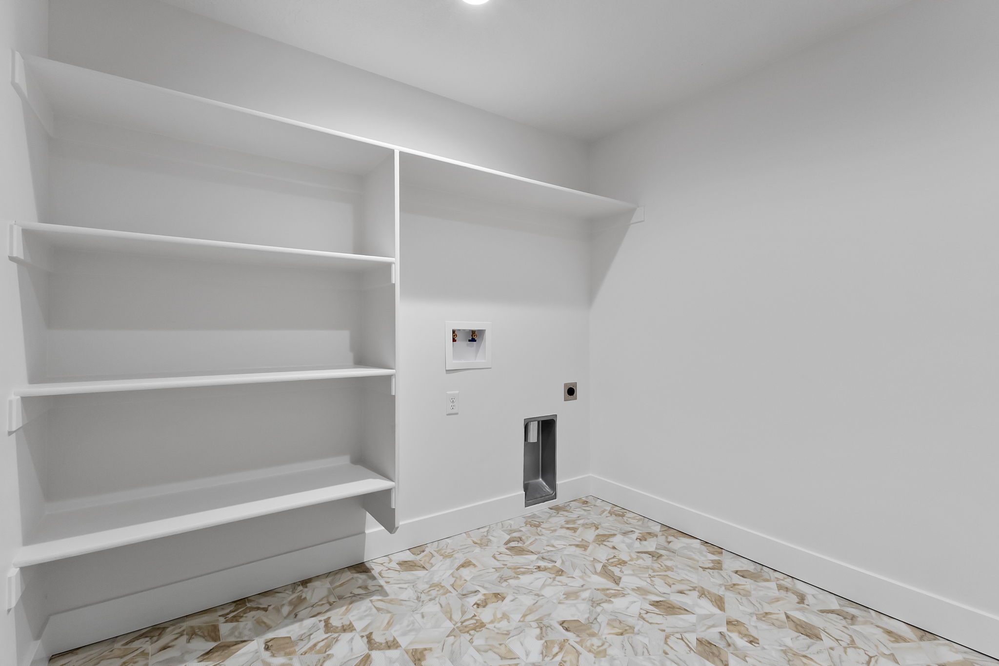Washroom with hookup for a washing machine and hookup for an electric dryer
