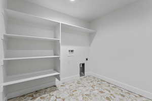 Washroom with hookup for a washing machine and hookup for an electric dryer