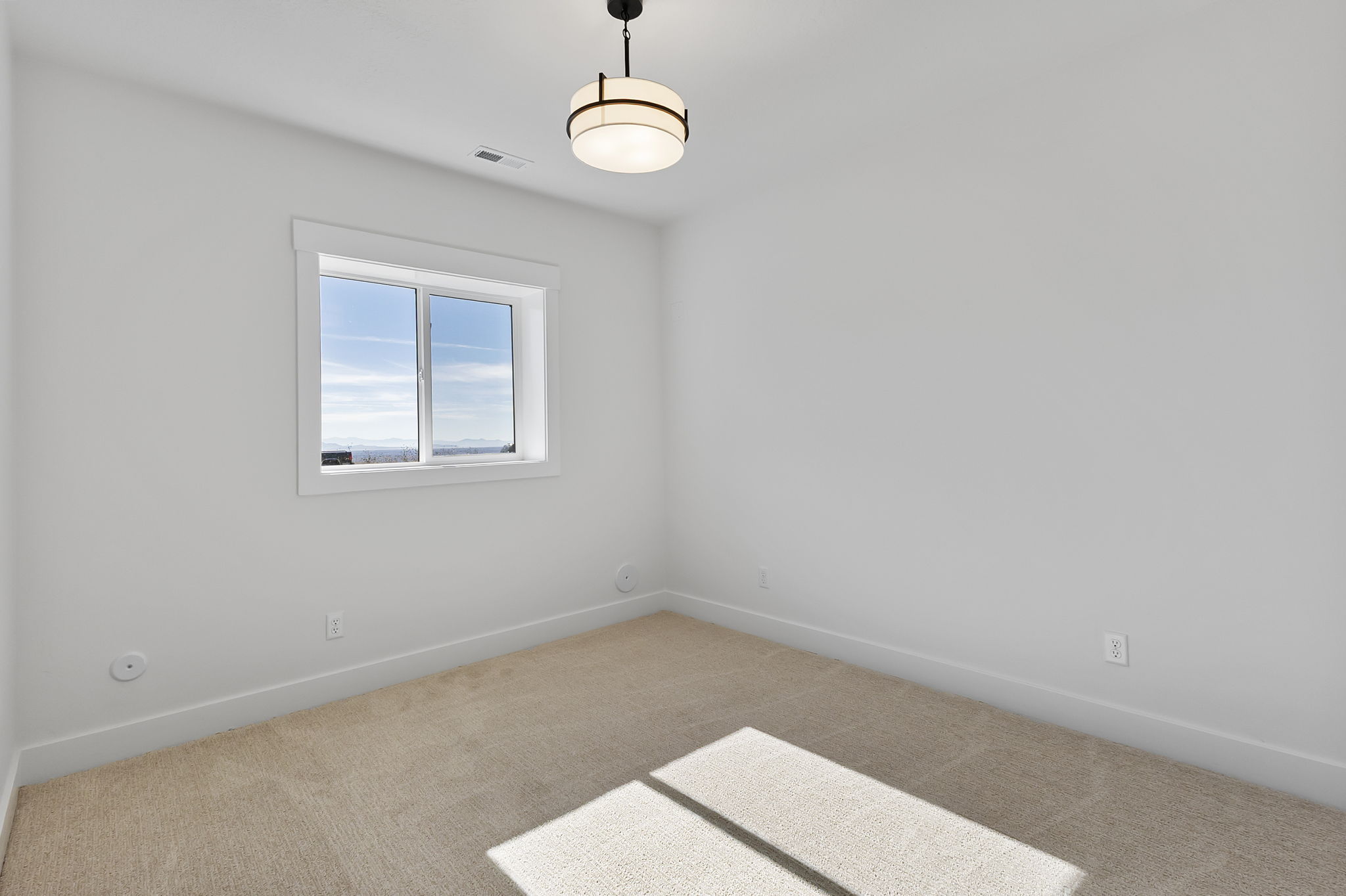 Neutral tone walls and carpeting create a versatile interior