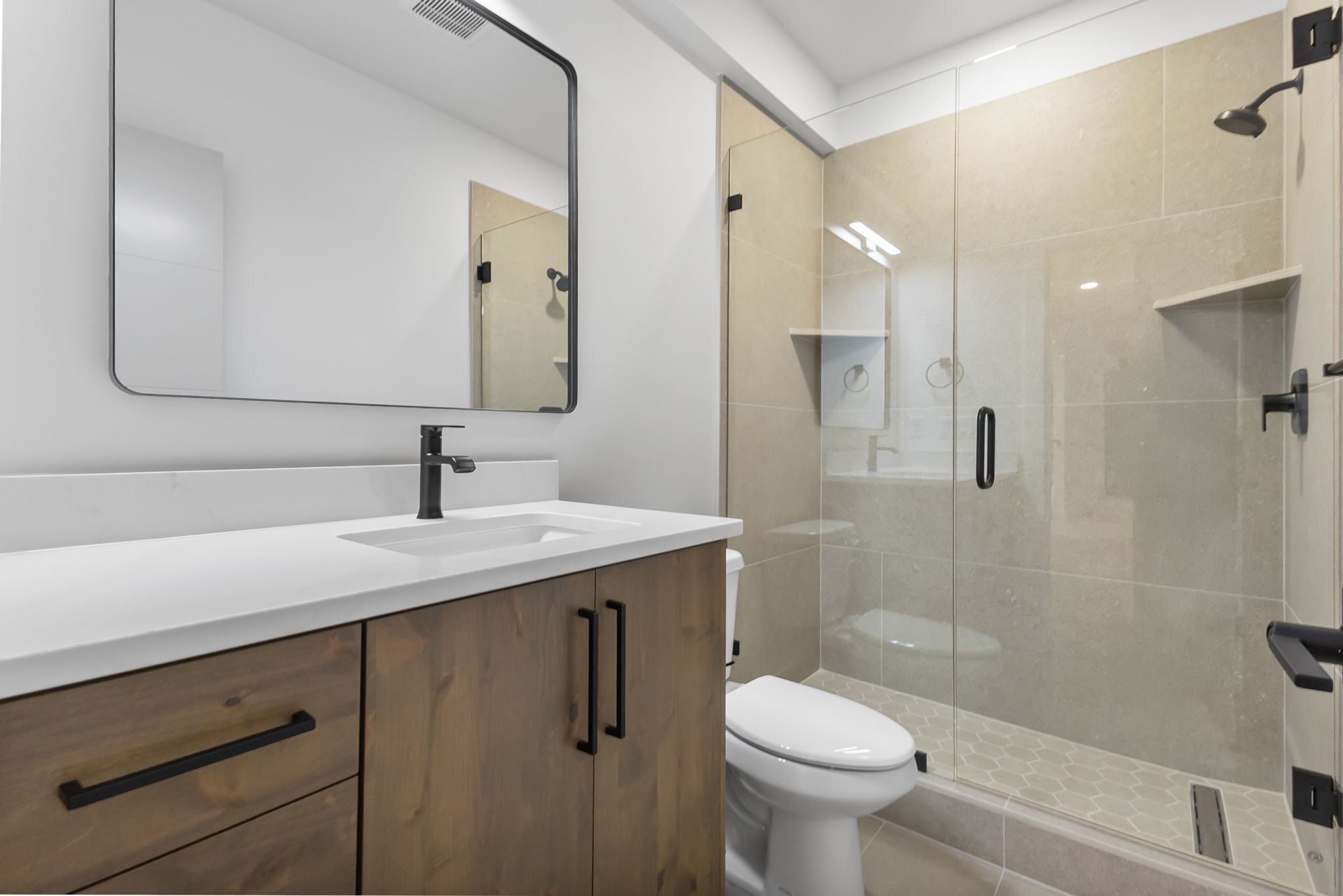 Full bathroom with a stall shower and vanity