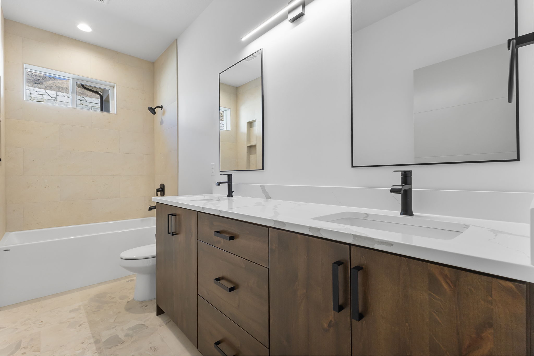 Bathroom featuring double vanity, shower / bath combination, and recessed lighting