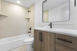 Full bathroom with bathing tub / shower combination, vanity, light tile patterned flooring, and recessed lighting