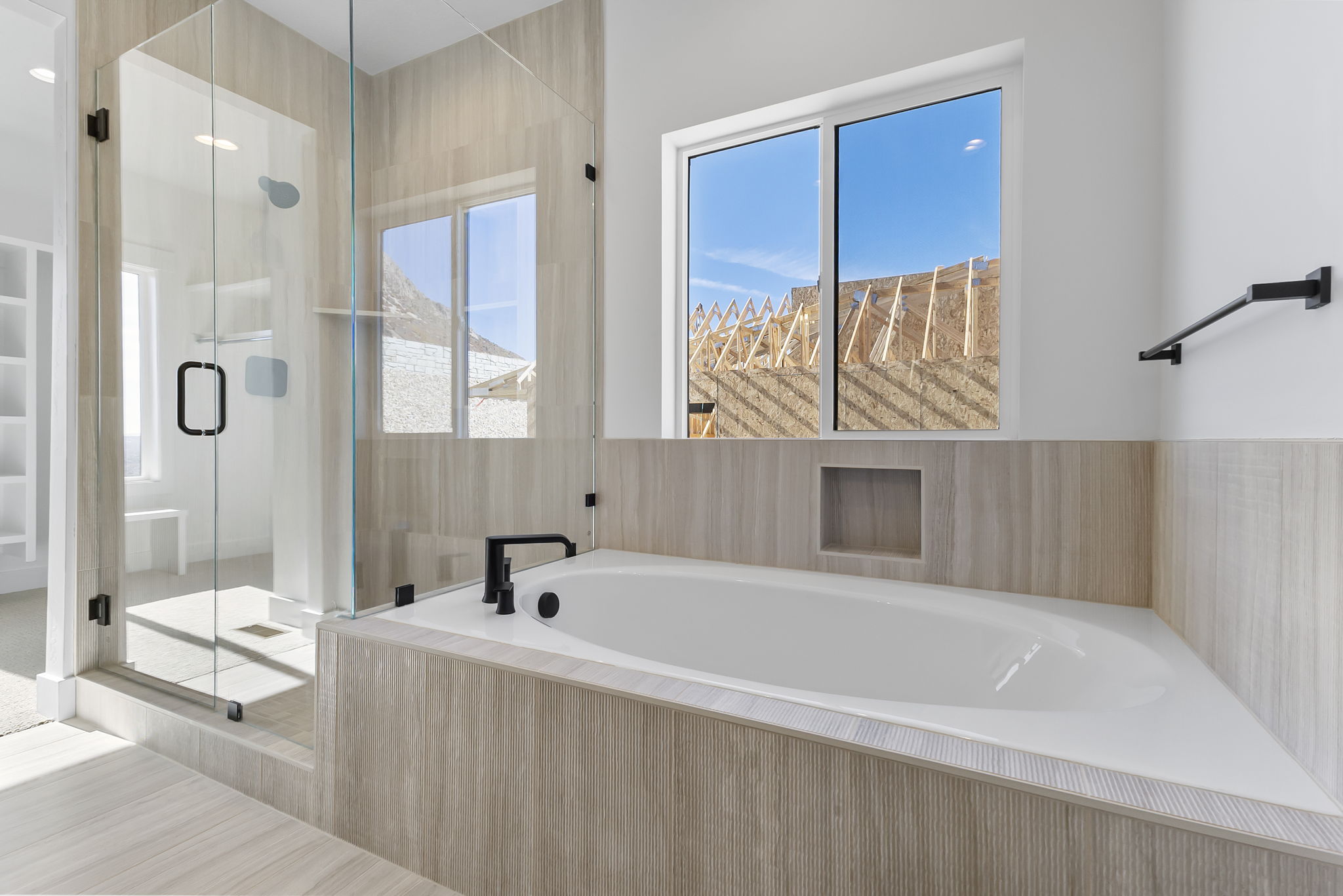 Full bathroom with a stall shower, a bath, and plenty of natural light