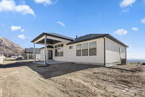 Back of house featuring a patio and a mountain view