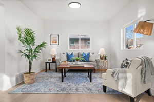 Living area with light wood-style flooring and baseboards