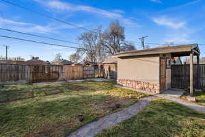 Fenced backyard with an outdoor structure
