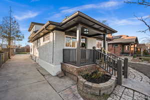 View of front of property with brick siding and covered porch