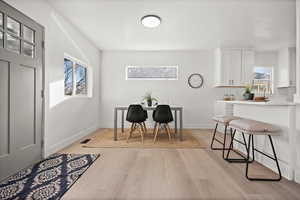 Dining space with light wood finished floors and baseboards