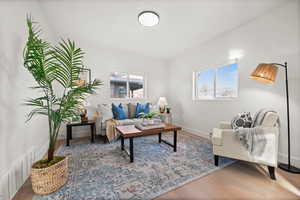 Living area with light wood finished floors and baseboards