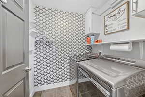 Laundry area featuring cabinet space and washing machine and dryer