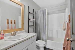Bathroom with shower / bath combo and vanity