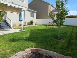 Fenced backyard with a patio and stairway