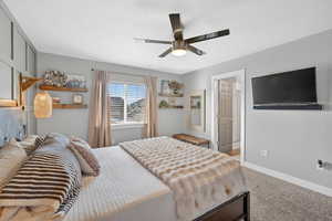 Bedroom with carpet floors, ceiling fan.