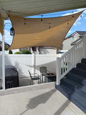 View of patio with area for grilling and an outdoor fire pit