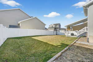 Fenced backyard with a patio