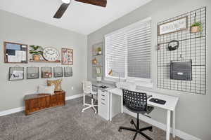 Office featuring dark colored carpet and a ceiling fan