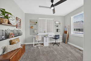 Home office featuring carpet flooring and ceiling fan