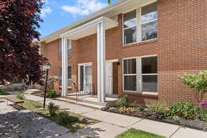 View of exterior entry featuring brick siding