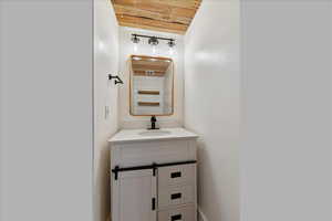 Bathroom featuring vanity and wooden ceiling
