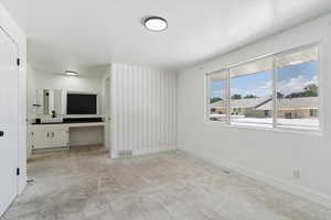 Spare room with light carpet and baseboards