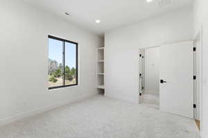Unfurnished bedroom featuring recessed lighting and light carpet