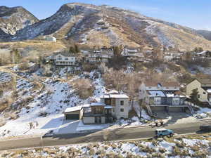 Snowy aerial view with a mountain view and a residential view