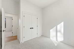Unfurnished bedroom featuring carpet flooring and a closet