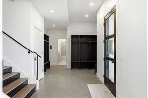 Mudroom with finished concrete floors and recessed lighting