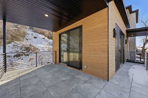Snow covered patio with a patio