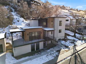 Snow covered property featuring a residential view and stucco siding