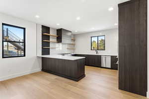 Kitchen with backsplash, a peninsula, open shelves, modern cabinets, and dark brown cabinetry