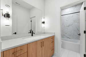 Bathroom with vanity and washtub / shower combination