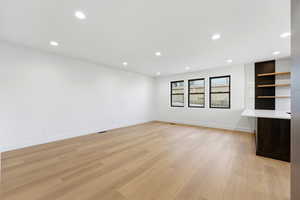 Unfurnished living room featuring light wood finished floors and recessed lighting