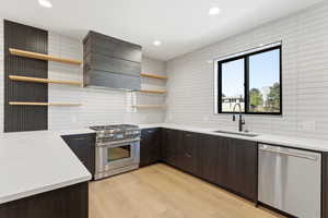 Kitchen featuring open shelves, stainless steel appliances, dark brown cabinetry, modern cabinets, and recessed lighting