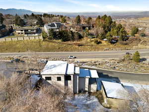 Aerial view of property and surrounding area with a mountainous background