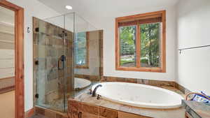 Full bath featuring a jetted tub, a stall shower, and recessed lighting