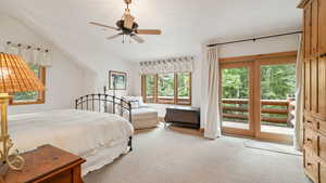 Carpeted bedroom with access to outside, a ceiling fan, and lofted ceiling