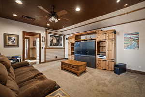 Living area featuring recessed lighting, ceiling fan, light carpet, and vaulted ceiling