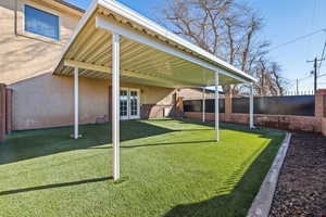 Fenced backyard featuring french doors and a patio area